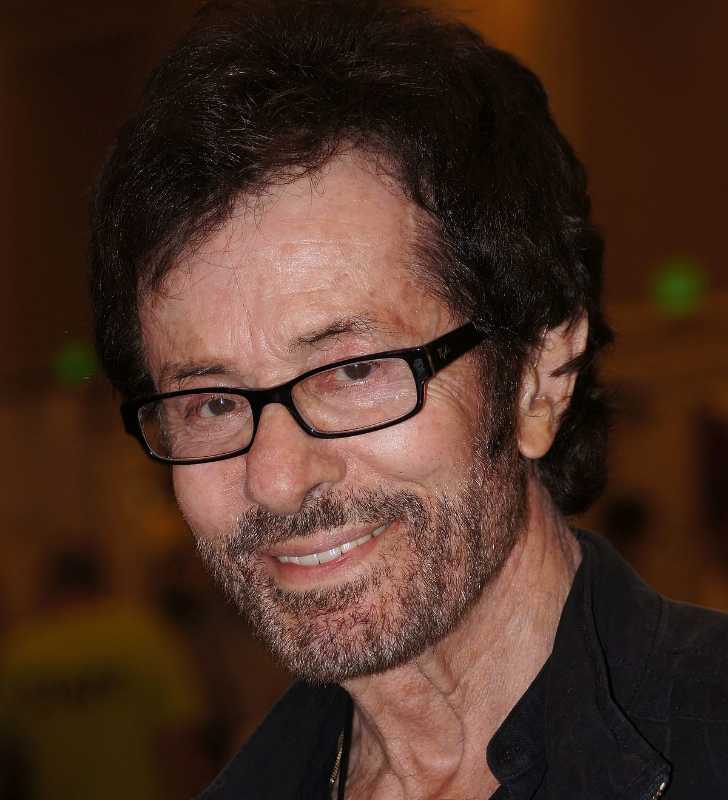 Picture of George Chakiris posing for a photo smiling and looking at camera